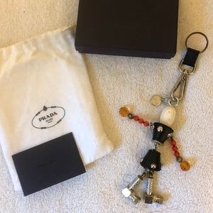 Prada robot keychain, made from metal & leather.